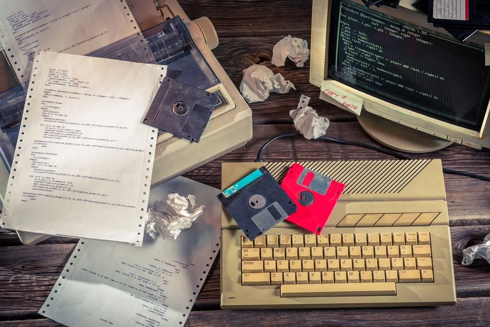 A recovered photograph of a compact retro computer setup with a small screen and keyboard.
